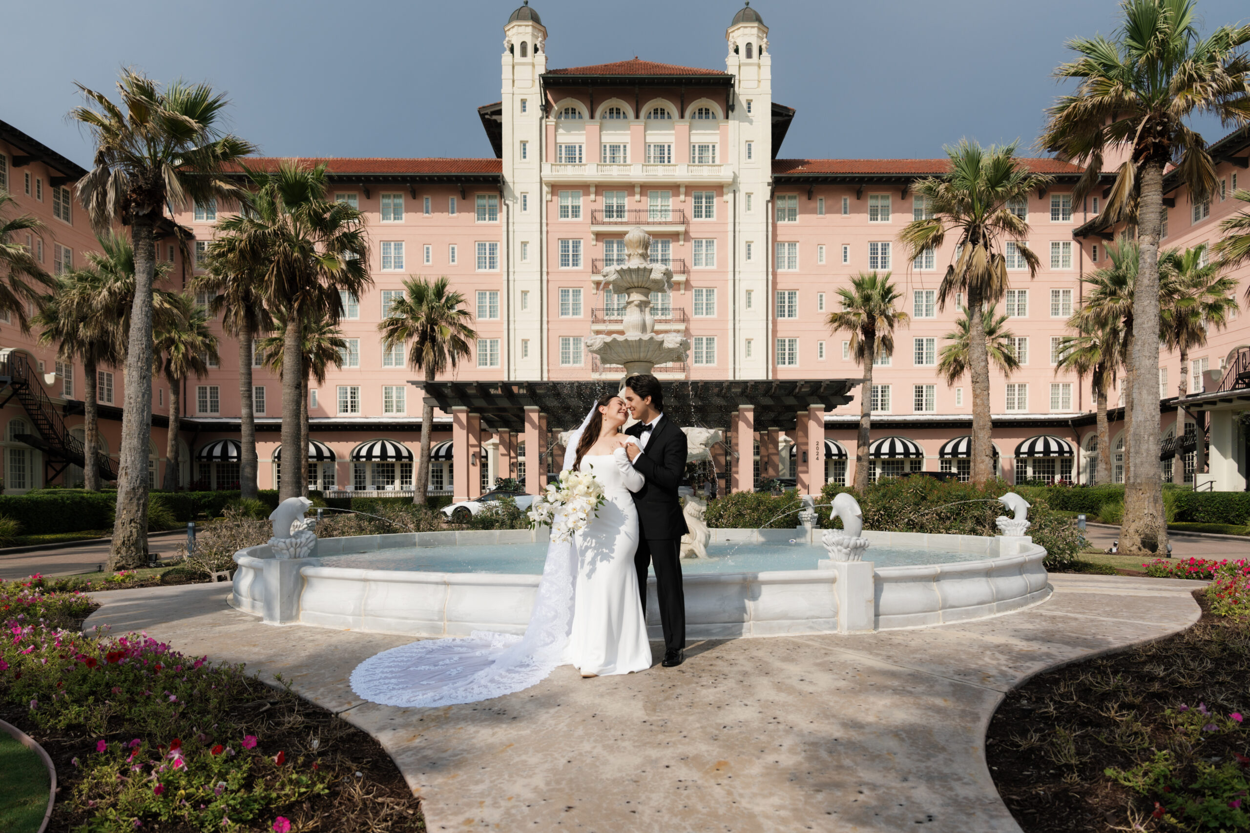 wedding couple in front of luxurious wedding venue