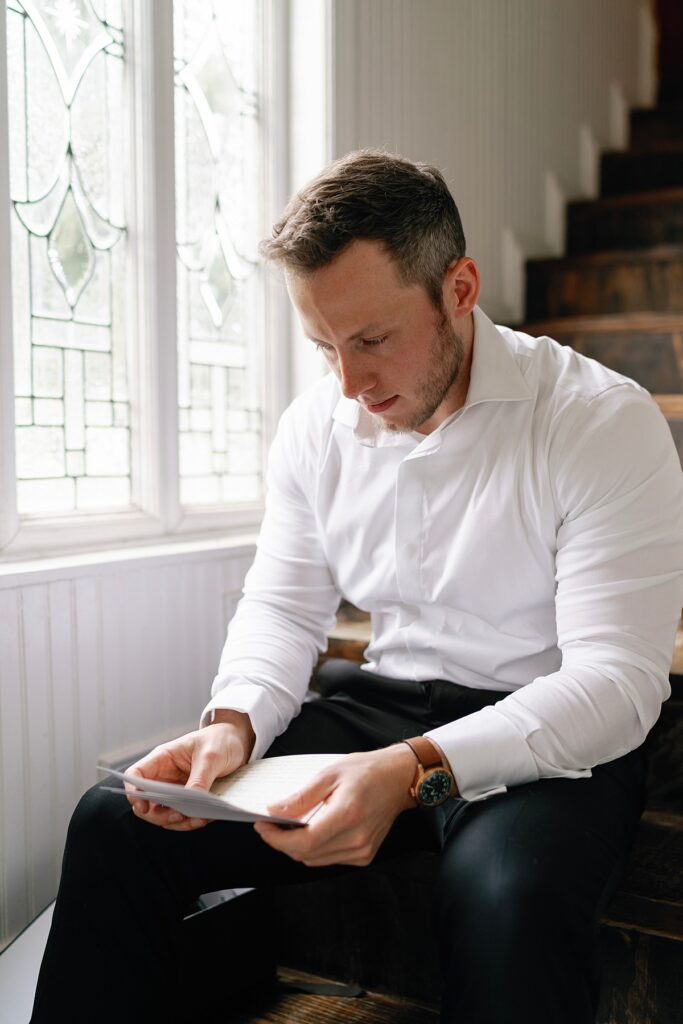 Groom reading letter from bride at Sandlewood Manor Tomball TX