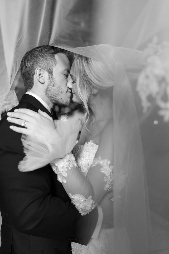 bride and groom kissing at Sandlewood Manor